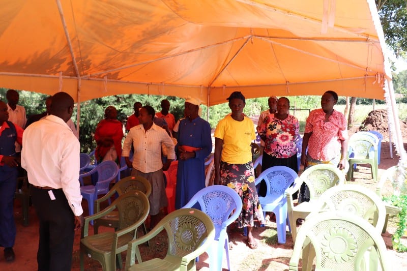 Village Enterprise business savings group members under their tent