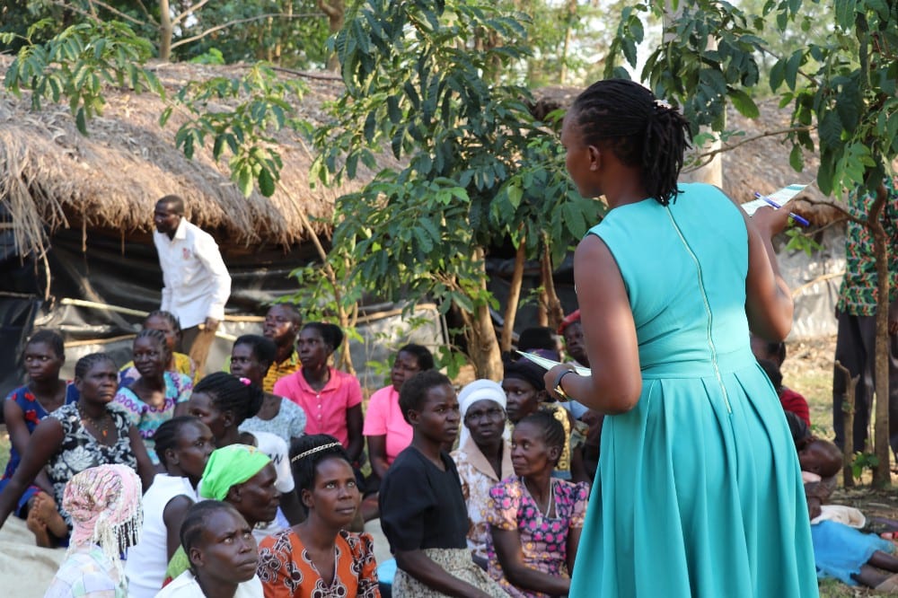 Zita Akwero mentoring Village Enterprise business owners in Nwoya, Uganda