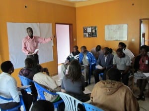 man presenting to Village Enterprise Hoima, Uganda, staff