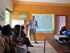man presenting to Village Enterprise Hoima, Uganda, staff