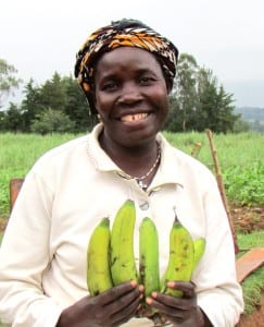 Emma, Village Enterprise business owner, holding bananas