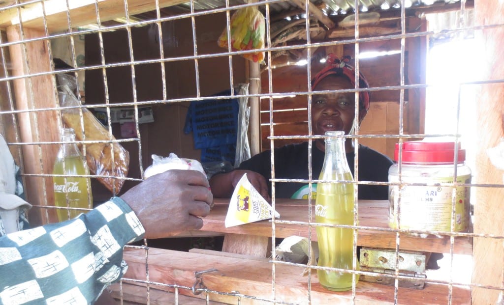 Jane Arara attending to her customers in her kiosk.