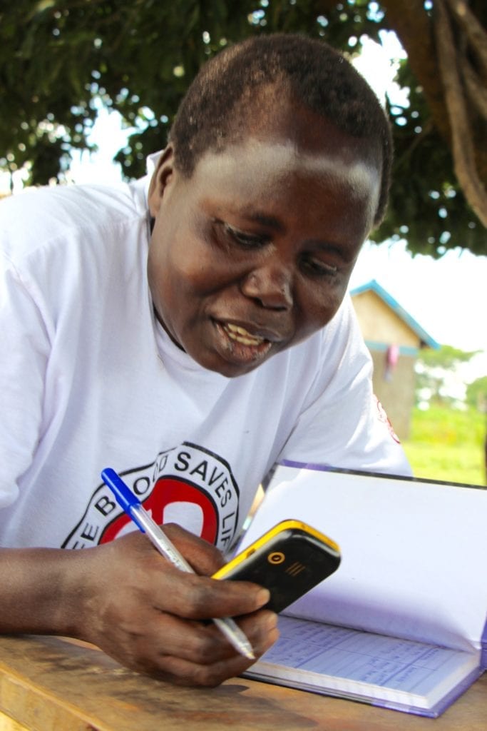 Ageyo Francis Janet tracks weekly savings for her savings group.