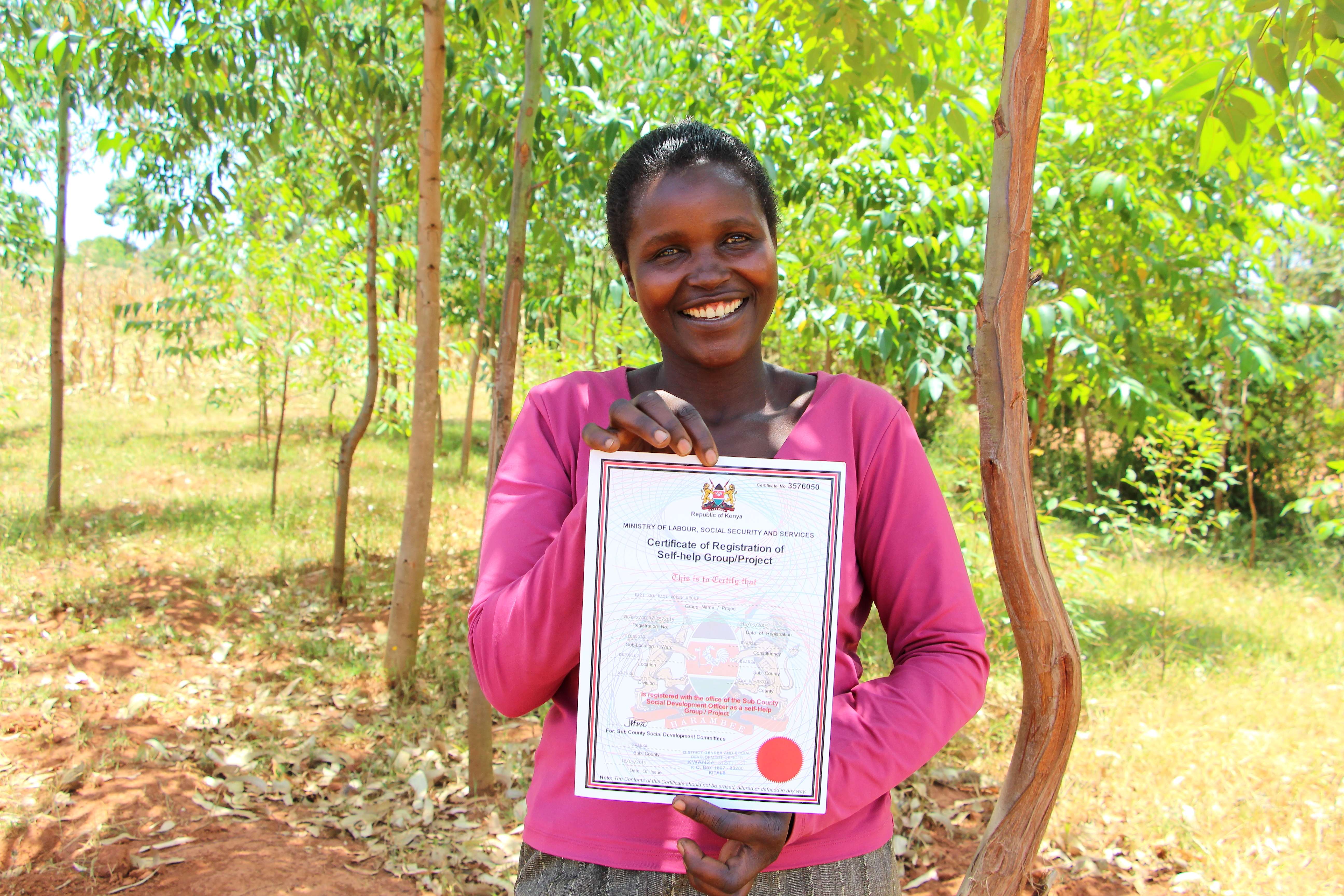 Agnes Naliaka with her Village Enterprise BSG’s certificate of registration