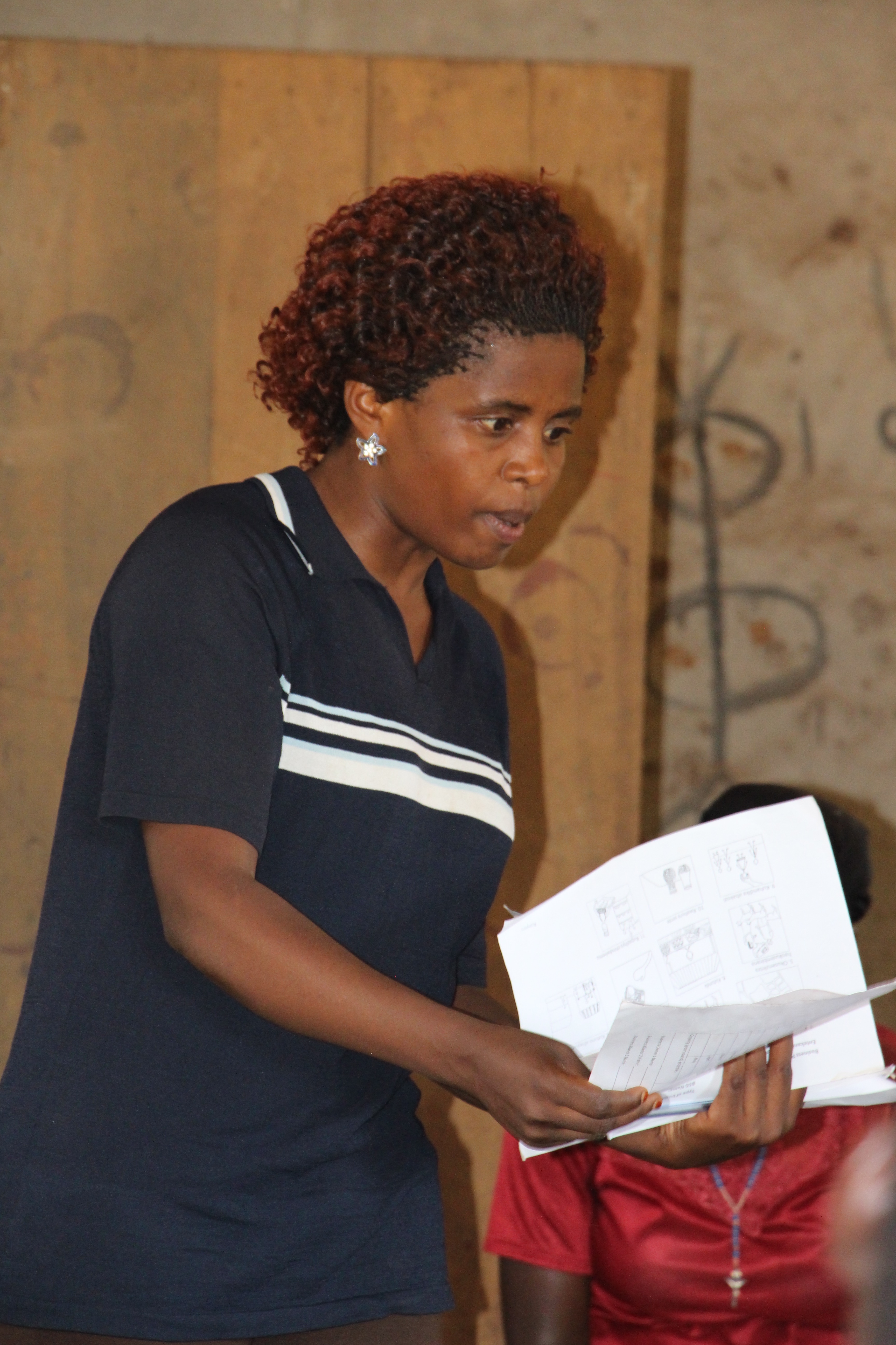 Mildred Wengozi explains the audit process to Village Enterprise business owners.