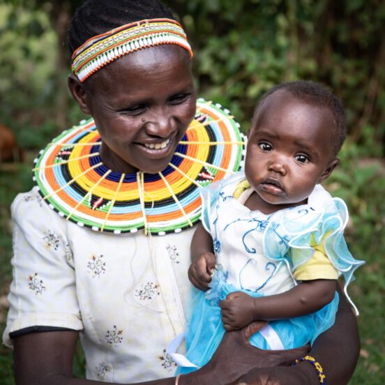 Smiling woman holding baby